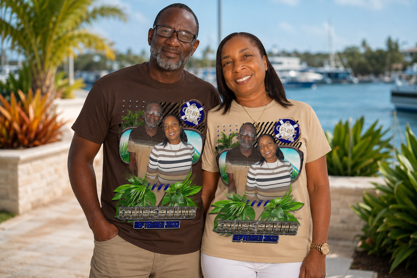 Two people wearing t-shirts with a graphic of a family and text, standing outdoors near water. 