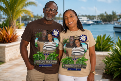 Two people wearing t-shirts with a graphic of a family and text, standing outdoors near water. 