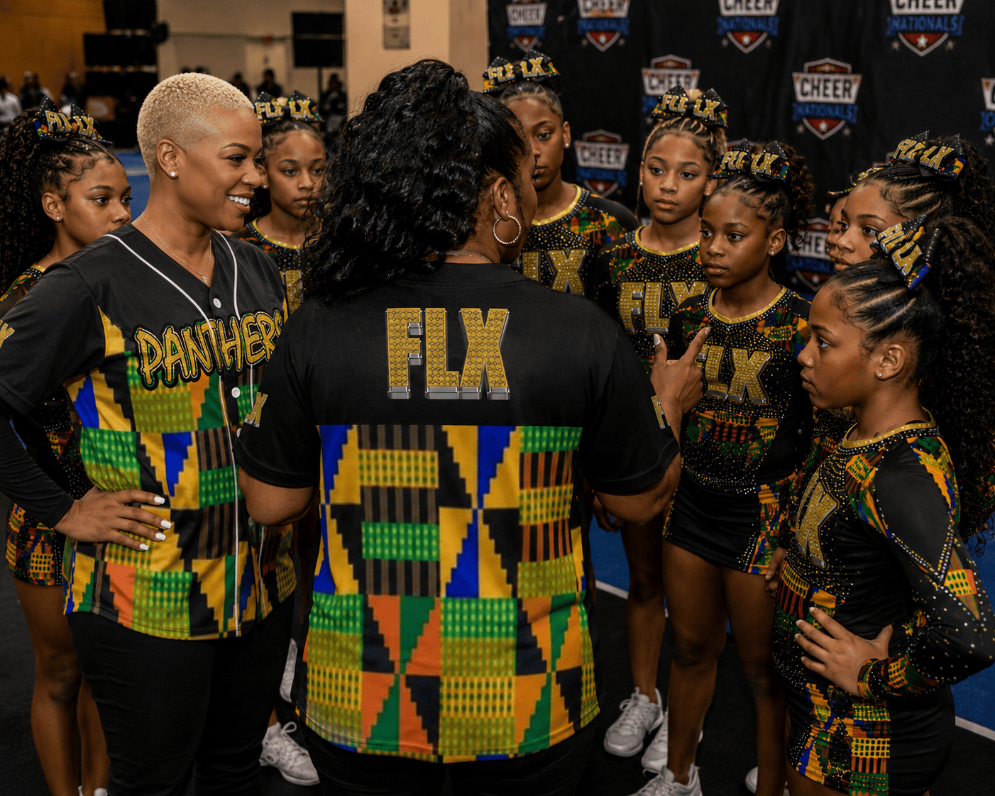 Group of cheerleaders in matching uniforms with 'FLX' branding, receiving instructions for cheer competition.